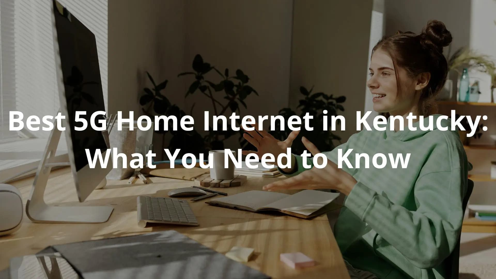 An individual, likely a woman, focused on their computer screen in a comfortable, informal home workspace.